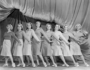 Coordinate: Portrait of line of female dancers on stage
