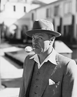 Fedora: Portrait of a man balancing an egg on a spoon in his mouth