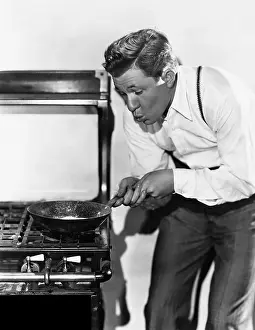 Intent: Portrait of man cooking on stove