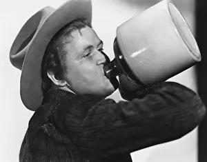 Liquors: Portrait of man drinking from jug