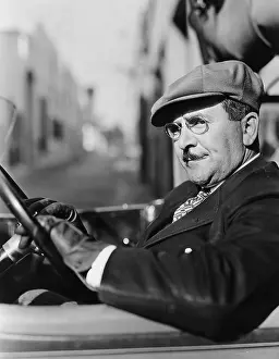 Skeptic: Portrait of man in drivers seat of car