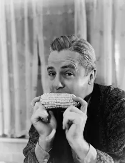 Sustenance: Portrait of a man eating a corn cob
