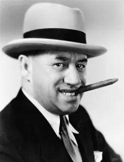 Close Crop: Portrait of a man with a hat and a cigar in his mouth