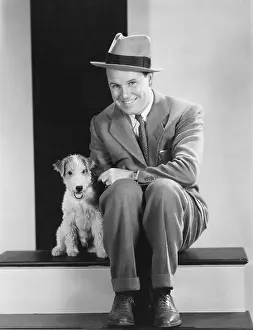 Wholesome: Portrait of man with puppy