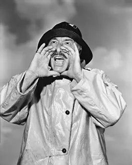 Raincoats: Portrait of man in raincoat yelling