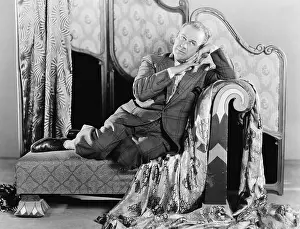 Unkempt: Portrait of a man sitting on a couch