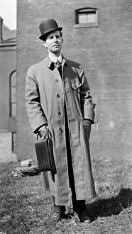 Phelps: Portrait Man Standing Bowler Hat Long Wool Coat Looking a