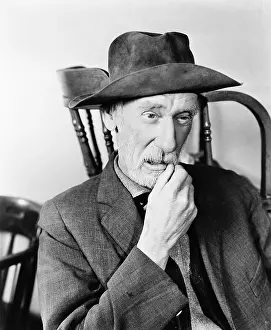 Daydreaming: Portrait of a man thinking and twirling his mustache