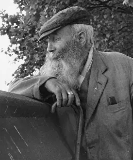 Straggly: Portrait of an old man with beard and walking stick