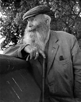Straggly: Portrait of an old man with beard and walking stick