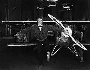 Silliness: Portrait of playful pilot with plane