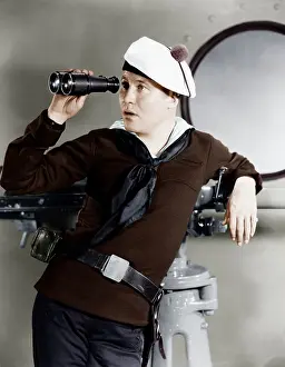 Nonchalant: Portrait of sailor looking through binoculars