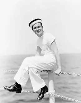 20 25: Portrait of a sailor sitting on the pole of a boat