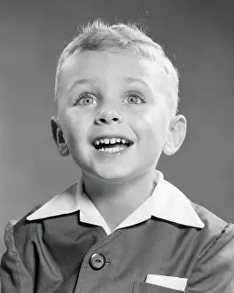 Glee: Portrait Smiling Blond Boy Looking up at Camera Excited