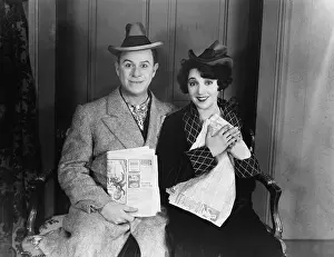 Excite: Portrait of smiling couple with newspapers