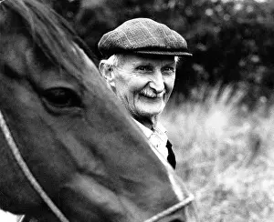 Lifelong: Portrait of smiling old man with horse