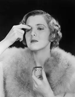 Eyelids: Portrait of woman applying makeup