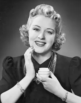 Softness: Portrait of woman applying makeup