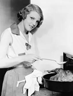 Wholesome: Portrait of woman basting bird