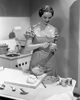 Peeling: Portrait of woman cooking in kitchen