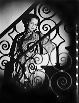 Sensual: Portrait of woman through decorative railing