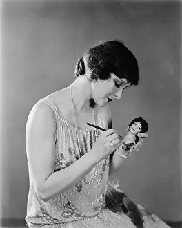 Focused: Portrait of woman with doll