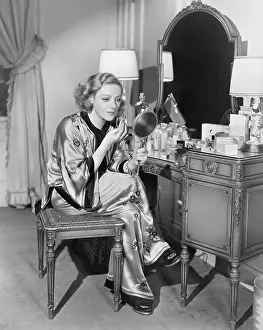 Focused: Portrait of woman at dressing table