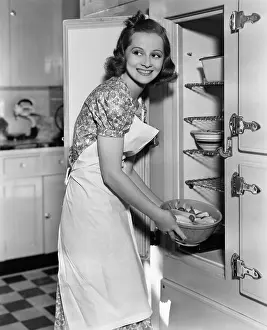 Storing: Portrait of woman in kitchen