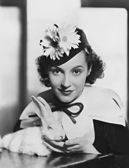 Petting: Portrait of woman with rabbit on Easter