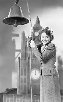 Announcements: Portrait of woman ringing bell with model clock tower