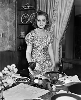 Hosting: Portrait of woman setting dining table