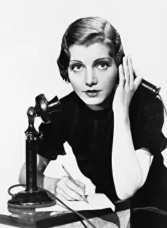 Informative: Portrait of woman on telephone taking notes