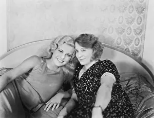 Friendliness: Portrait of two women lying on a bed