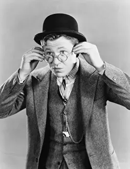 Bowlers: Portrait of young man putting on glasses