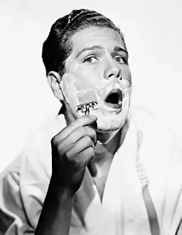 Razors: Portrait of a young man shaving