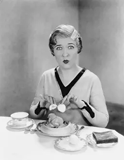 Startling: Portrait of a young woman opening eggshells with