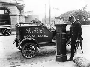 Mailman: Postman parked next to postbox
