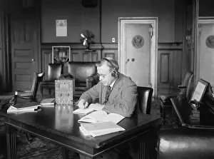 Earphones: Postmaster General Hubert Work listening to a radio