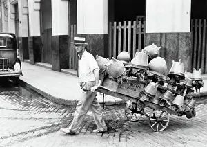 Pal001: Pot Salesman Looking at Camera Pulling his Cart Full of