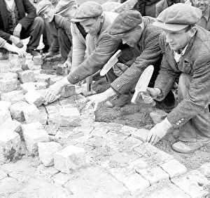 Cobble: Prague 1938, cobble stone layers at work