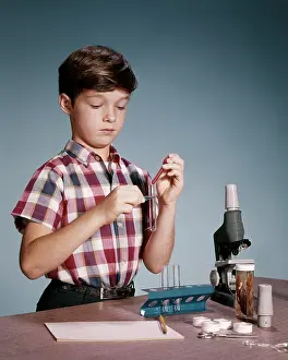Preteen: Pre-Teen Boy Playing with Test Tube Microscope