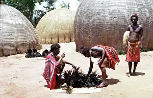 Swazi: Preparing headdresses, beehive huts