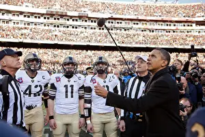 Referees: President Barack Obama performs the coin toss before