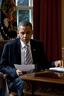 African Americans: President Barack Obama reads a document in the Oval
