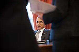 Advisors: President Barack Obama talks with advisors in the