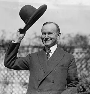 Prescott: President Calvin Coolidge waves a hat