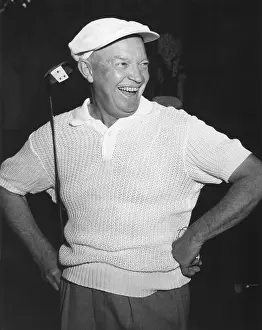 Rs6wnlcgr: President Dwight Eisenhower smiling while golfing
