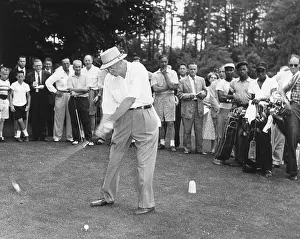 Teeing: President Dwight Eisenhower teeing off. His audience