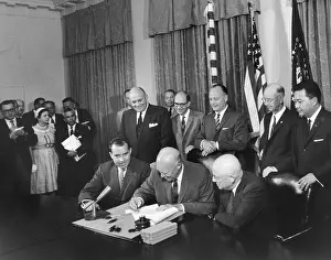 Raeburn: President Eisenhower signing a proclamation formally