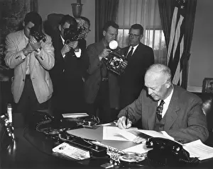 Photojournalists: President Eisenhower signing a Resolution to Promote